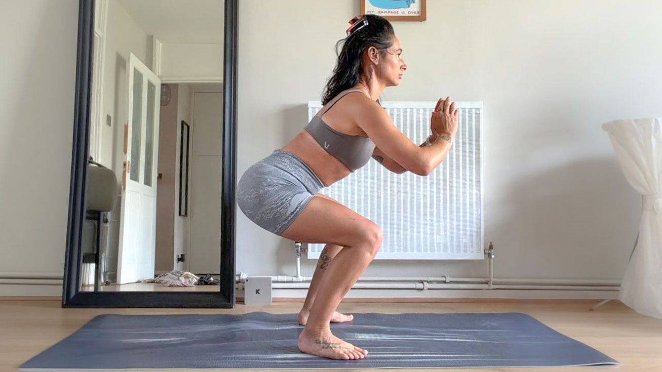 Sam performing squat at home on yoga mat
