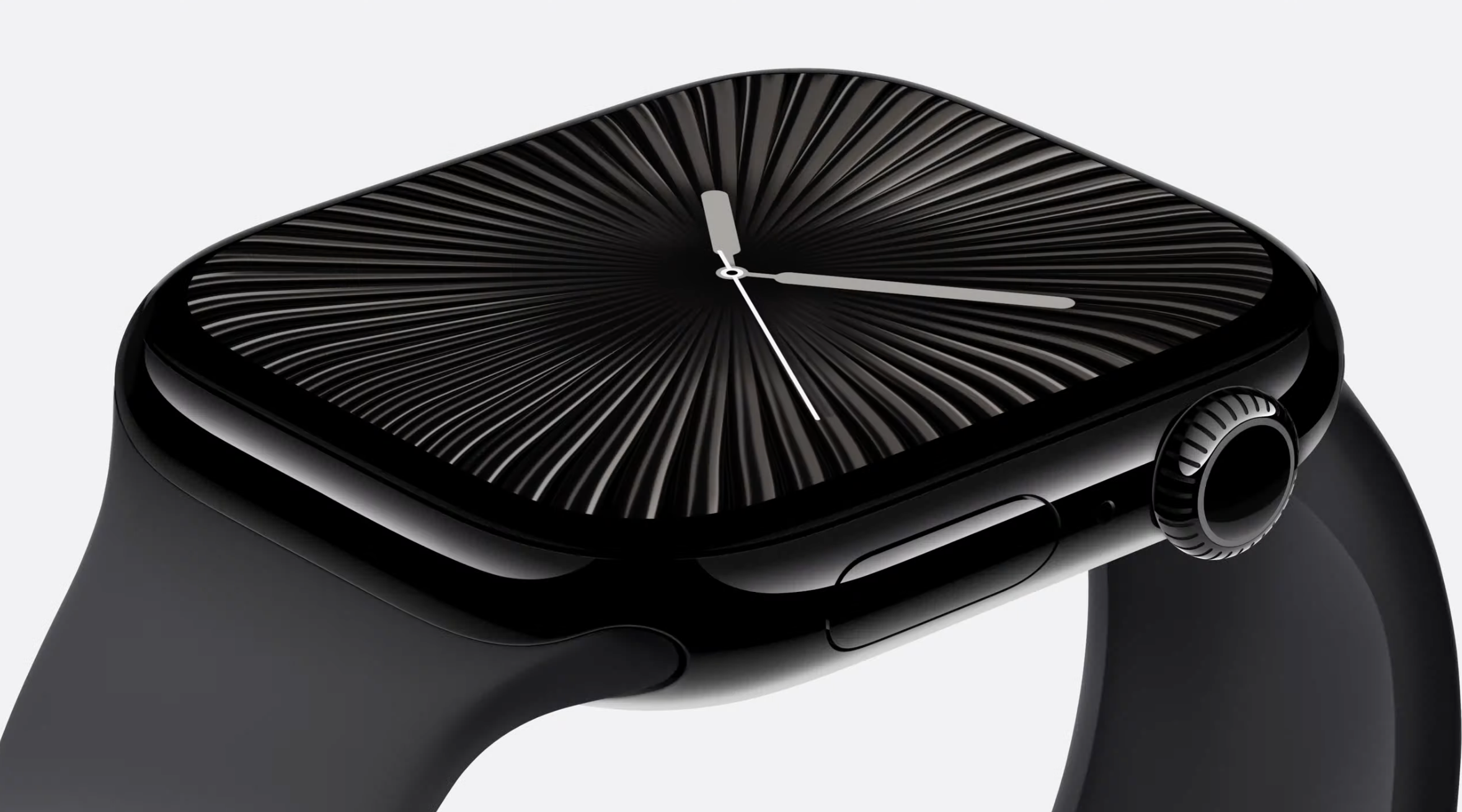 A closeup of the black Apple Watch Series 10, displaying an analog clock face, set against a white background.