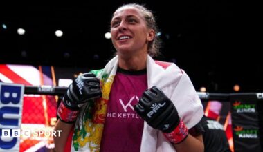 Dakota Ditcheva wearing MMA gloves with a flag draped over her shoulders