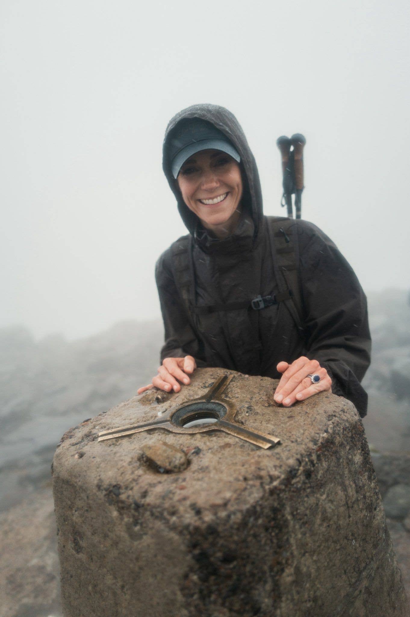 Princess Kate in a baseball cap hiking up a mountian 