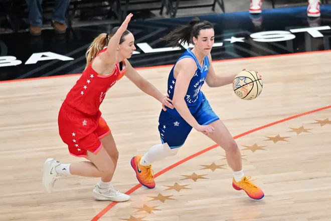 Jul 25, 2026; Chicago, Illinois, USA; Team Spoon guard Caitlin Clark (22) drives past Team Coop guard Paige Bueckers (5) in the second half during the 2026 WNBA All-Star Game at the United Center. Mandatory Credit: Patrick Gorski-Imagn Images