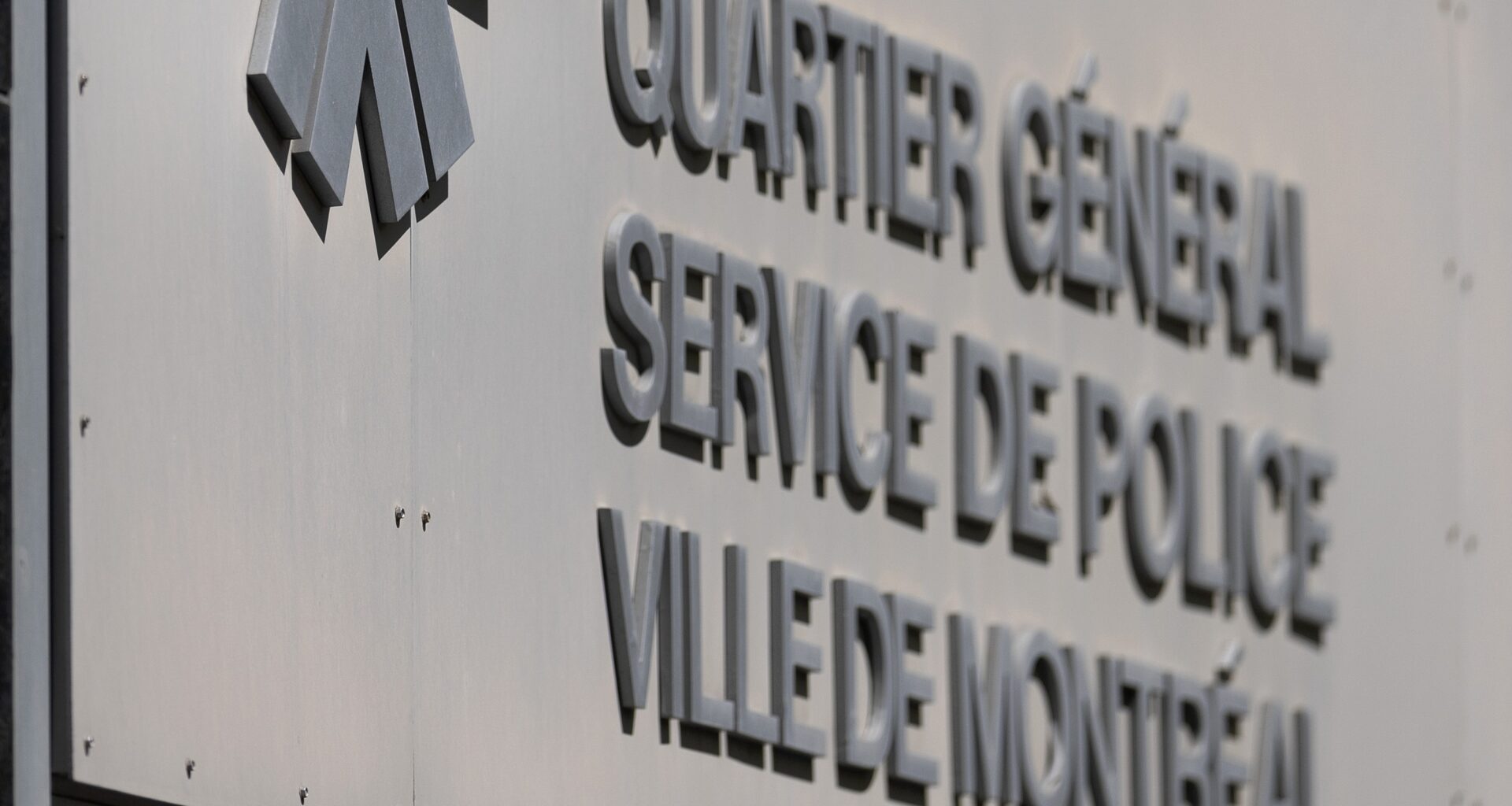 The Montreal police, SPVM logo on the wall of the headquarters building in Montreal.