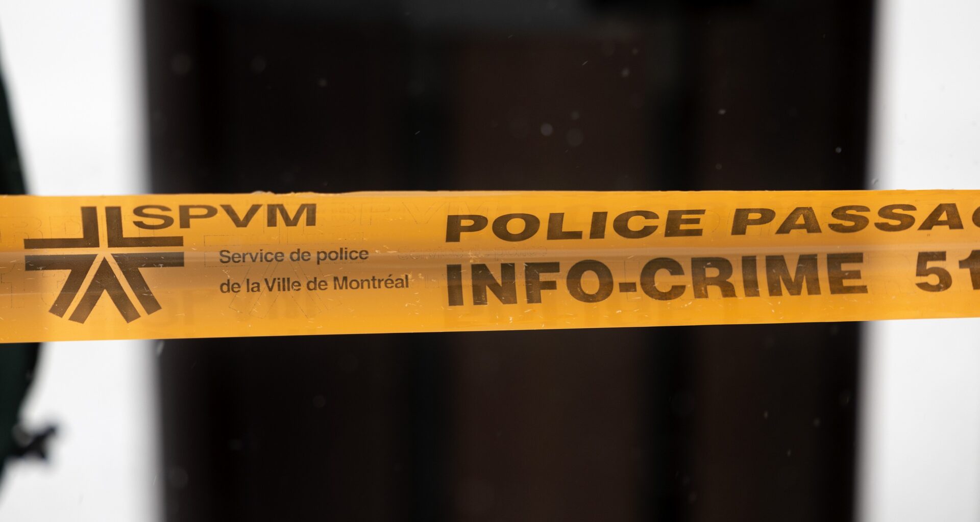 Montreal police tape blocks access to a street in Montreal.