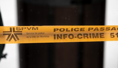 Montreal police tape blocks access to a street in Montreal.