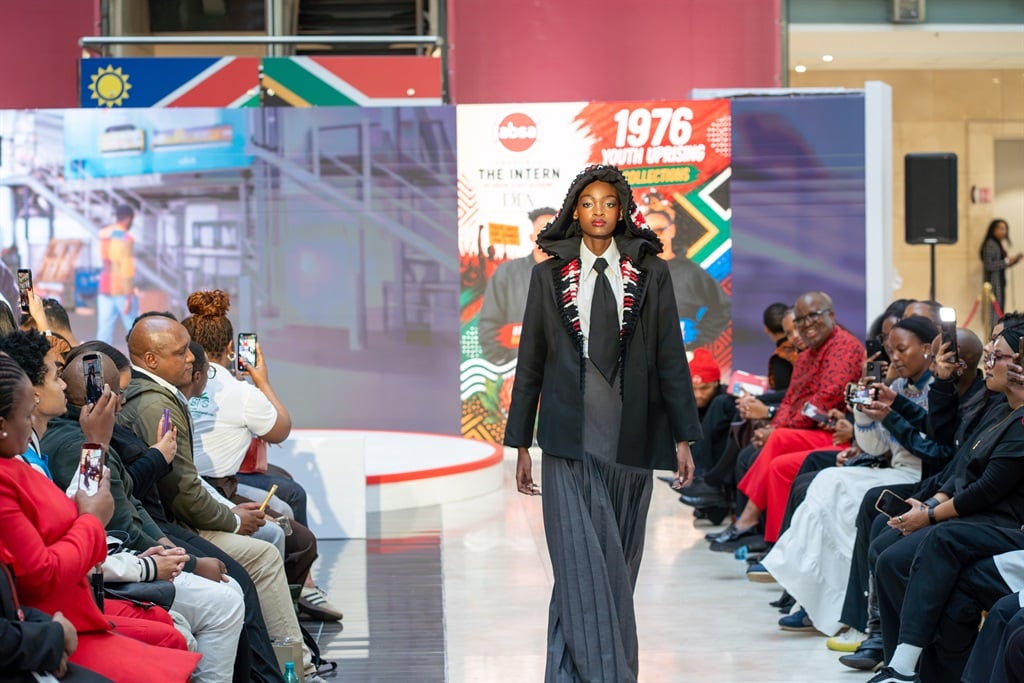 A model showcases a creation inspired by the legacy of the 1976 Youth Uprising during the Absa Youth Month event. Photo supplied creating jobs