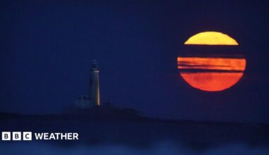The Full Buck supermoon rises over St Mary's Lighthouse in Whitley Bay on the north east coast of England in July 2023