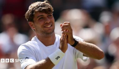 Flavio Cobolli applauds the Wimbledon crowd after his win over Alex de Minaur
