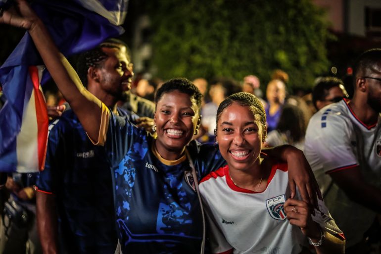 Supporters of Cape Verde's national football team celebrate after their team qualified for the knockout stage of the 2026 World Cup in Praia, on June 27, 2026. (Photo by JOSE CORREIA / AFP)