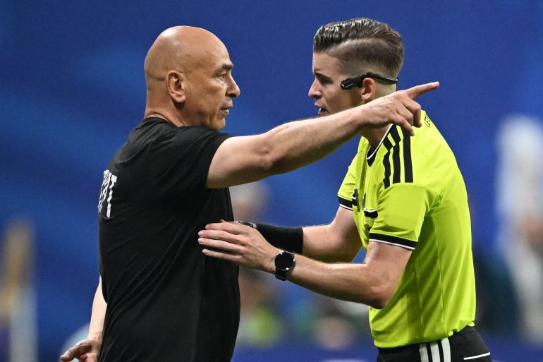 Egypt's head coach Hossam Hassan speaks with French referee Francois Letexier during the 2026 World Cup round of 16 football match between Argentina and Egypt at Atlanta Stadium in Atlanta on July 7, 2026. (Photo by ROBERTO SCHMIDT / AFP)