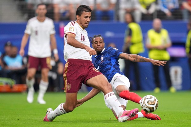 Spain's Rodri (16) and France's Michael Olise (11) vie for the ball during the World Cup semifinal last Tuesday in Arlington, Texas. (AP Photo/Eric Gay)