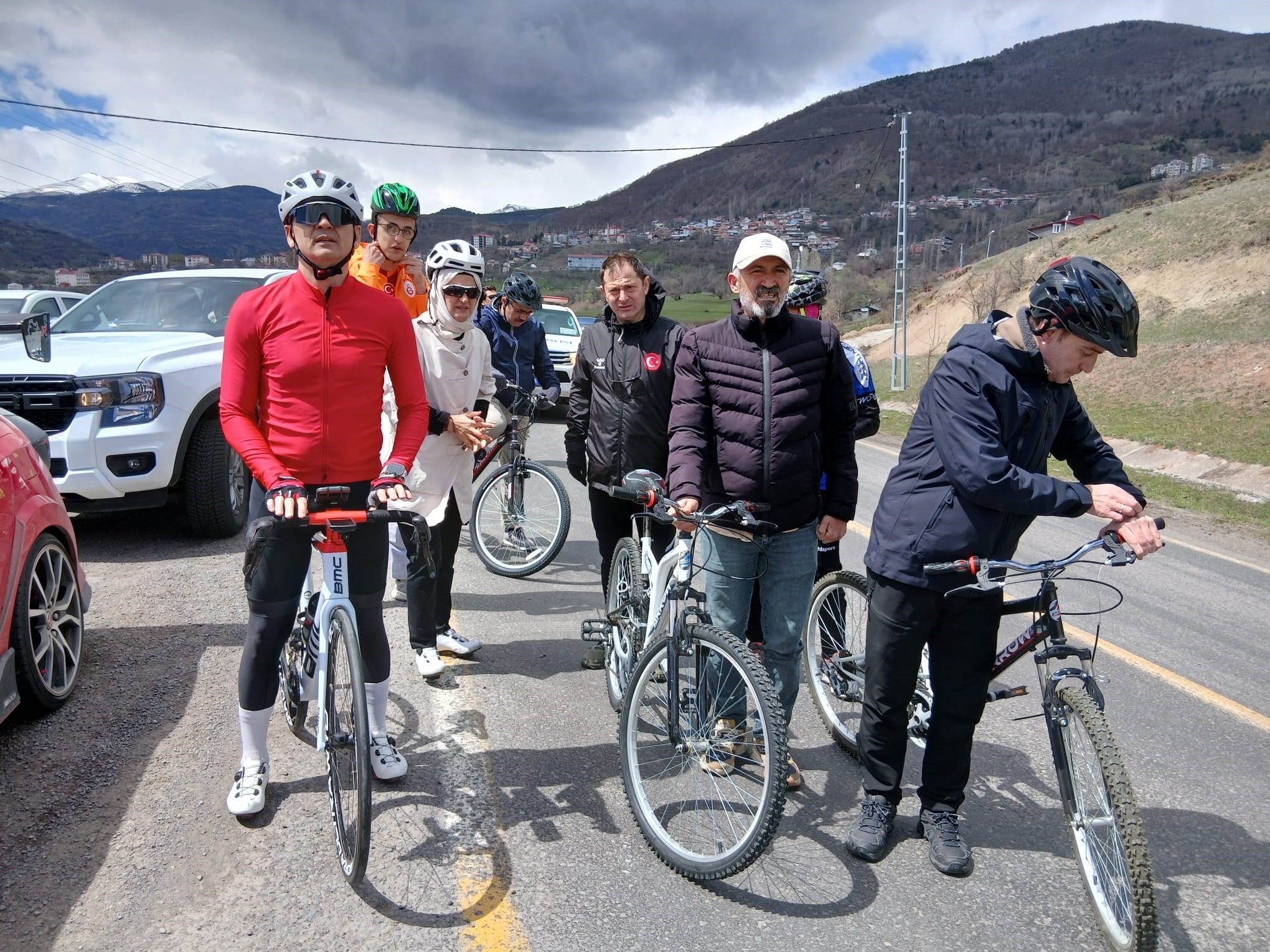Governor of Ardahan province Mehmet Fatih Cicekli, left, takes part in a popular cycle tour to promote tourism