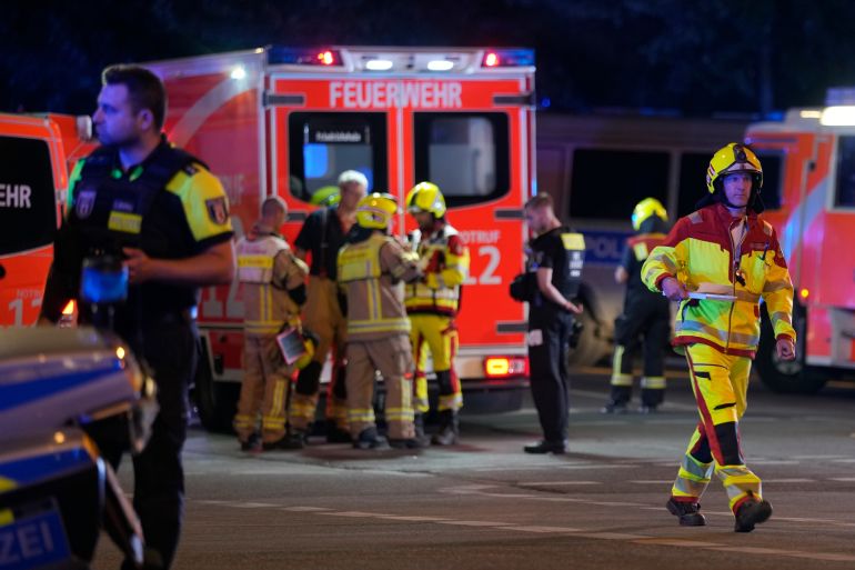 Emergency personnel gather after a car crashed into the crowd at Tiergarten park