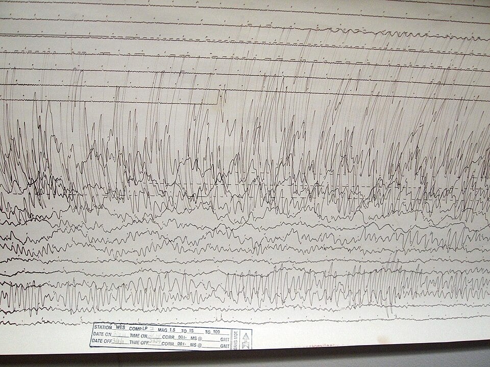 A real seismogram, showing the kind of trace scientists study every day. Buried in charts just like this one, researchers spotted an unusual N-shaped spike, the signature of a decaying shock wave from the Alaska fireball, hiding among the ordinary earthquake data.
