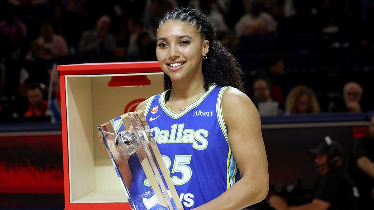 Azzi Fudd poses with the trophy after winning the 3-point contest.