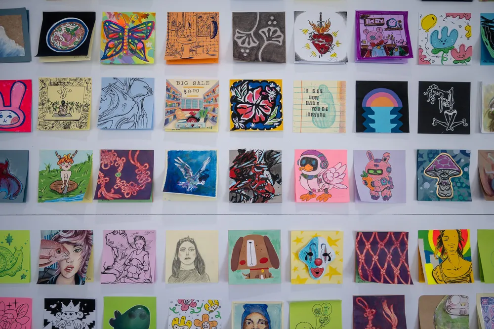 A wall of sticky notes with various patterns and designs
