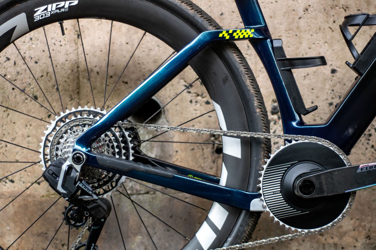An Argon 18 Anti Matter gravel bike leaning against a concrete wall.