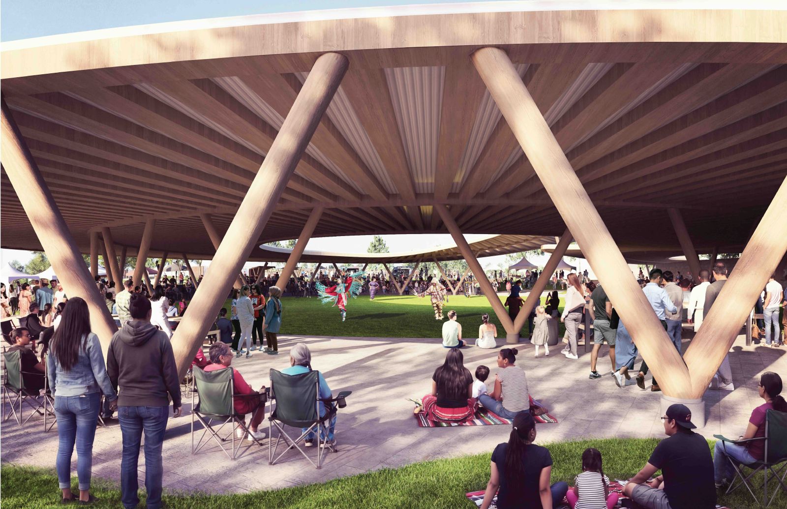 A concept plan features large wooden structures under which people are gathered in casual small groups. In the background, a person is dancing in the grass in traditional Indigenous regalia. The people gathered under the wooden structure are chatting or watching the dancer.