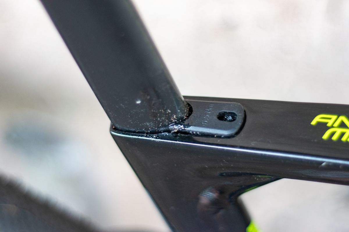 An Argon 18 Anti Matter gravel bike leaning against a concrete wall.