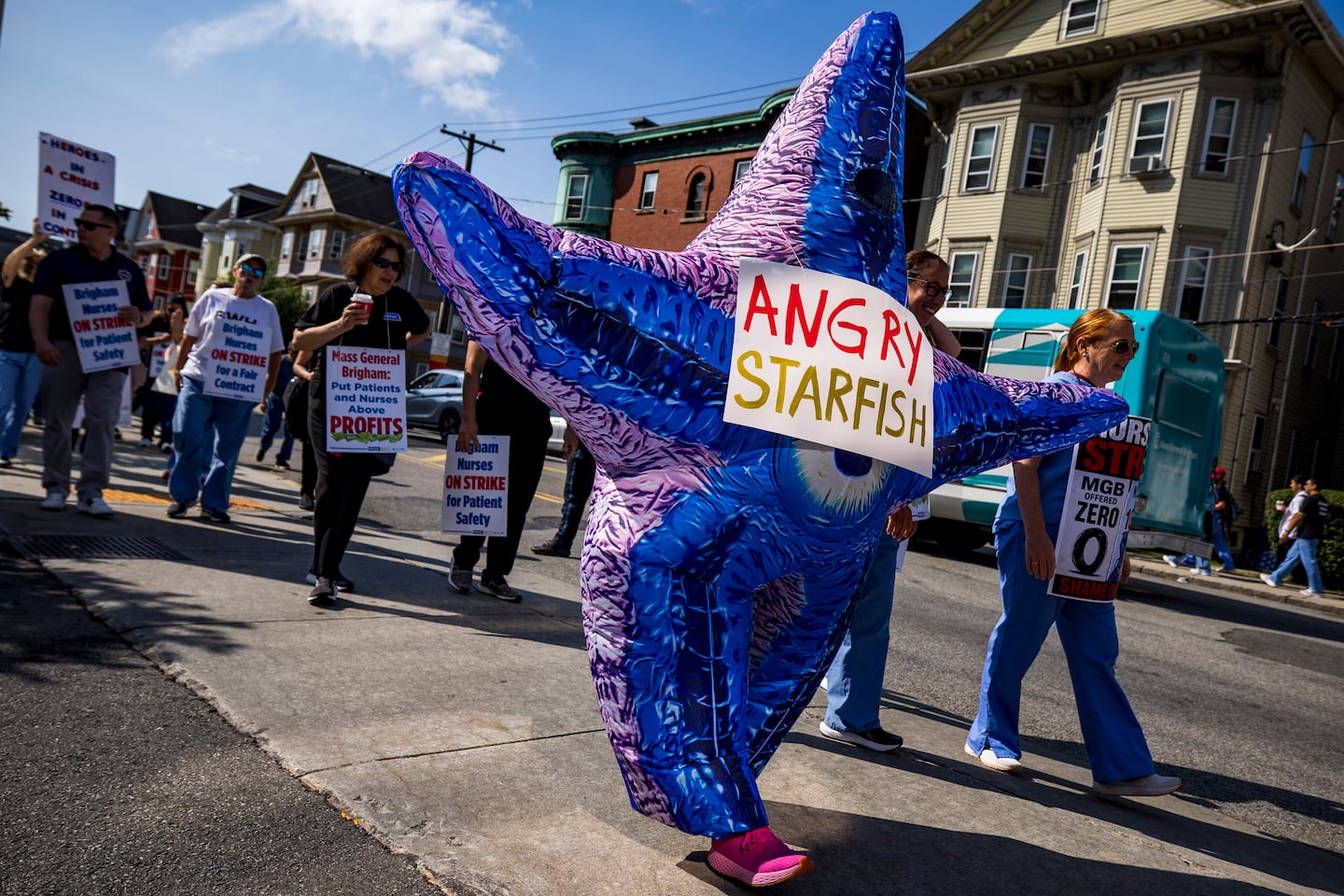 Yaeko Karatonis, wearing a starfish suit, marched during the first day of the nurses walkout outside Brigham and Women's Hospital on Wednesday.