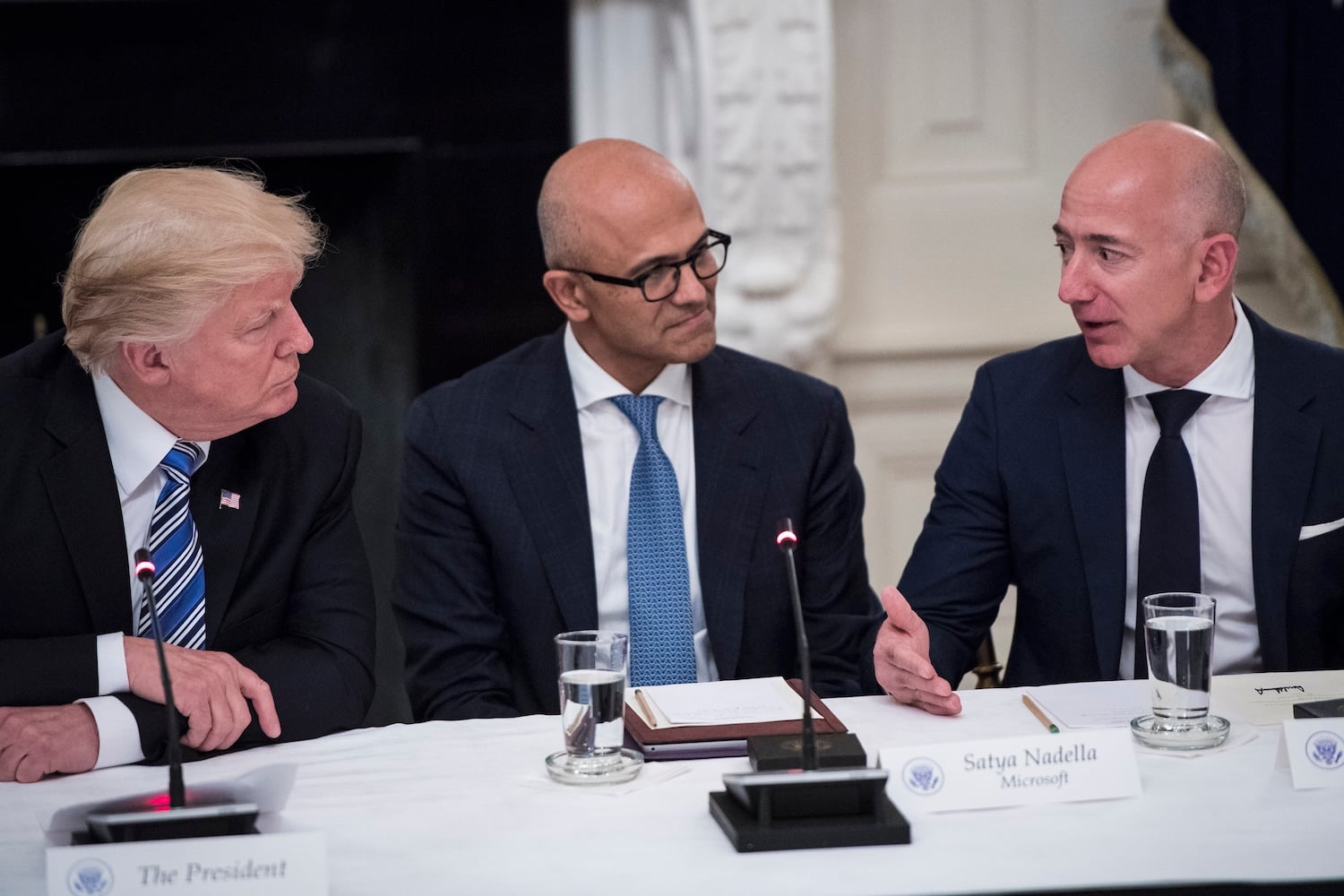 President Donald Trump speaks with Satya Nadella, Chief Executive Officer of Microsoft, and Jeff Bezos, Chief Executive Officer of Amazon