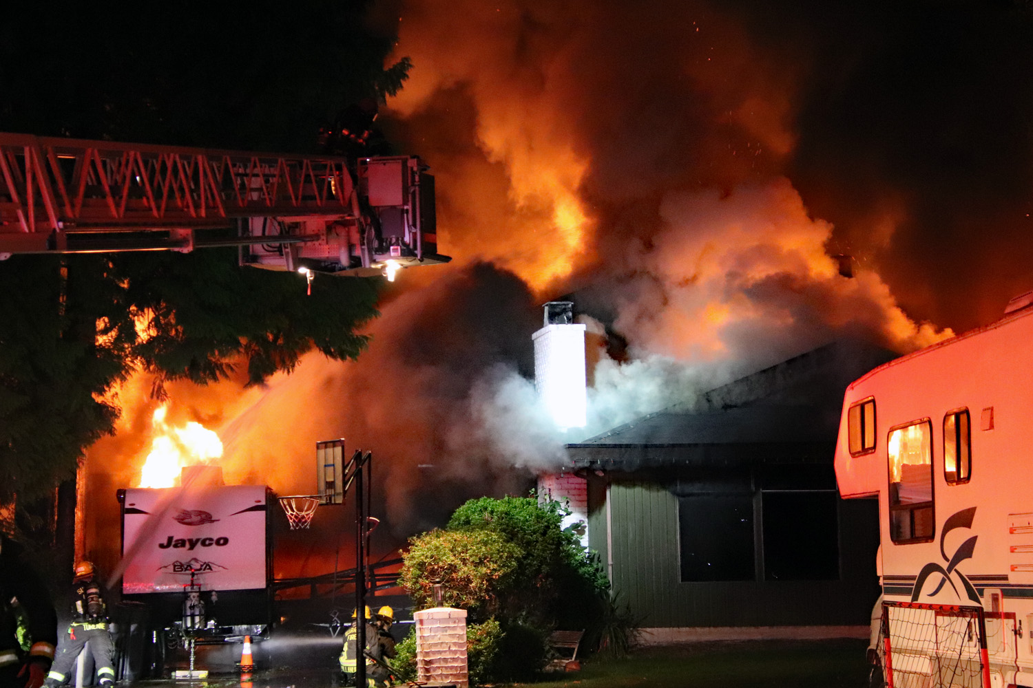 Fire crews were seen battling a blaze at a home on Edinburgh Place in Surrey late July 8, 2026.