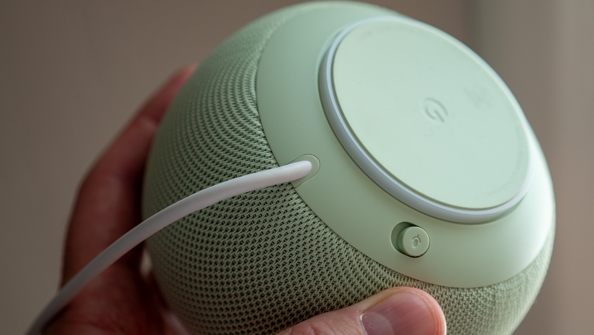 The non-removable power cable and mute button on the underside of the Jade Google Home Speaker