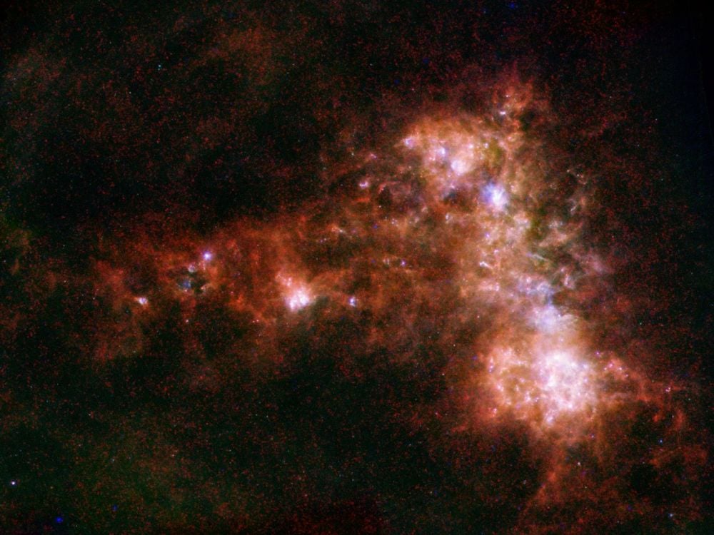 This infrared image of the Small Magellanic Cloud is a composite image from the ESA's Herschel Observatory and NASA's Spitzer Space Telescope. Image Credit: ESA/NASA/JPL-Caltech/STScI. Licence: ESA Standard Licence
