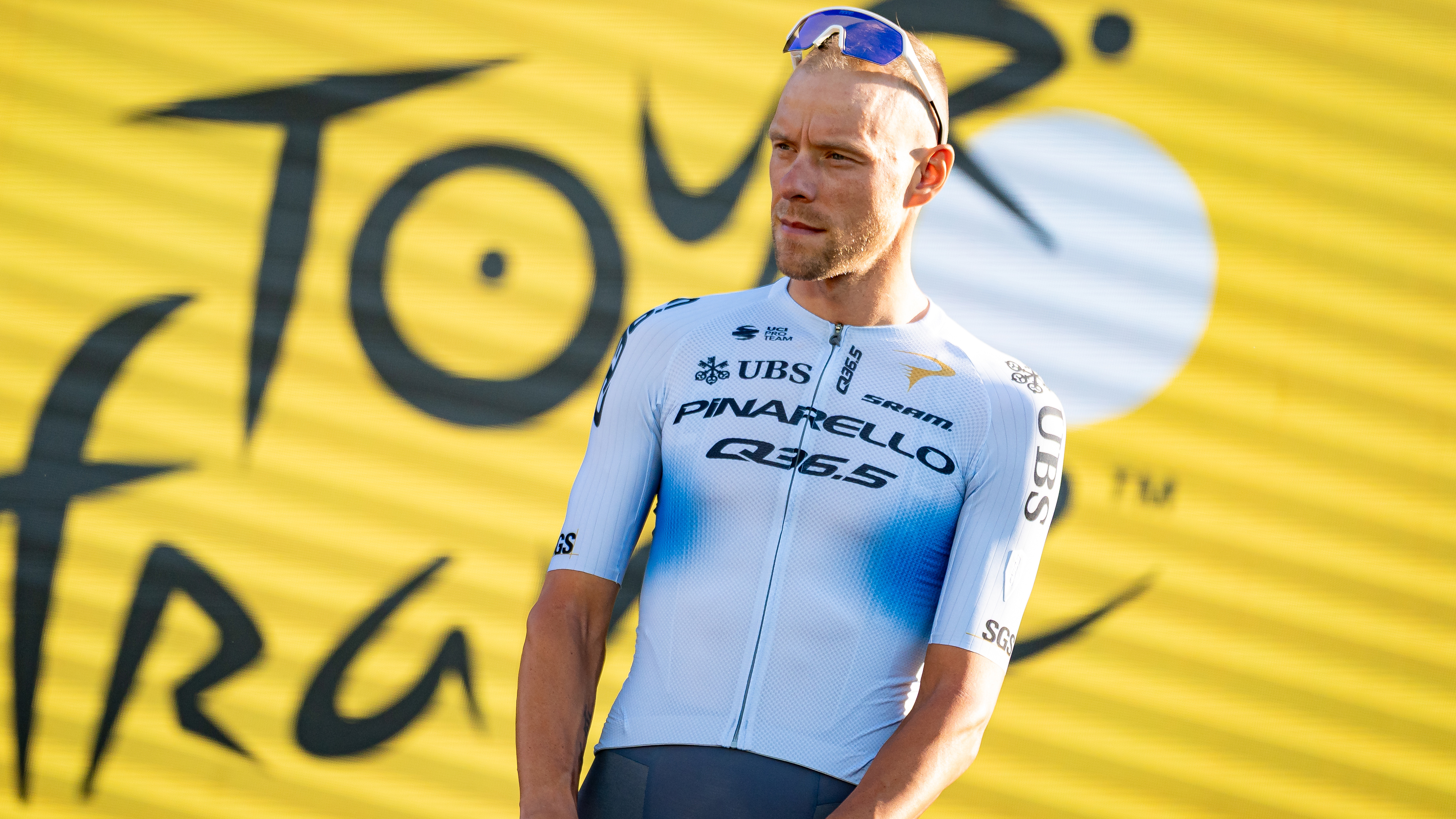 Xandro Meurisse of Pinarello-Q36.5 stands on stage in front of the Sagrada Familia basilica during the Tour de France 2026 team presentation ceremony