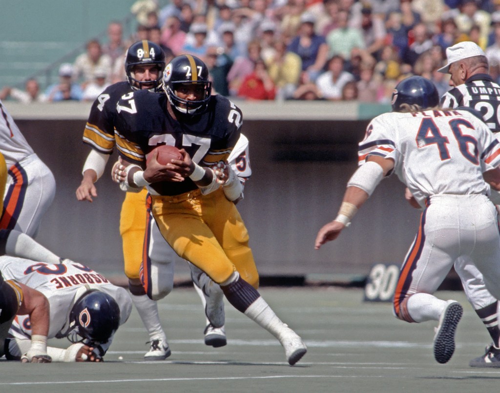 Pittsburgh Steelers player #27 running with the football during a game against the Chicago Bears.