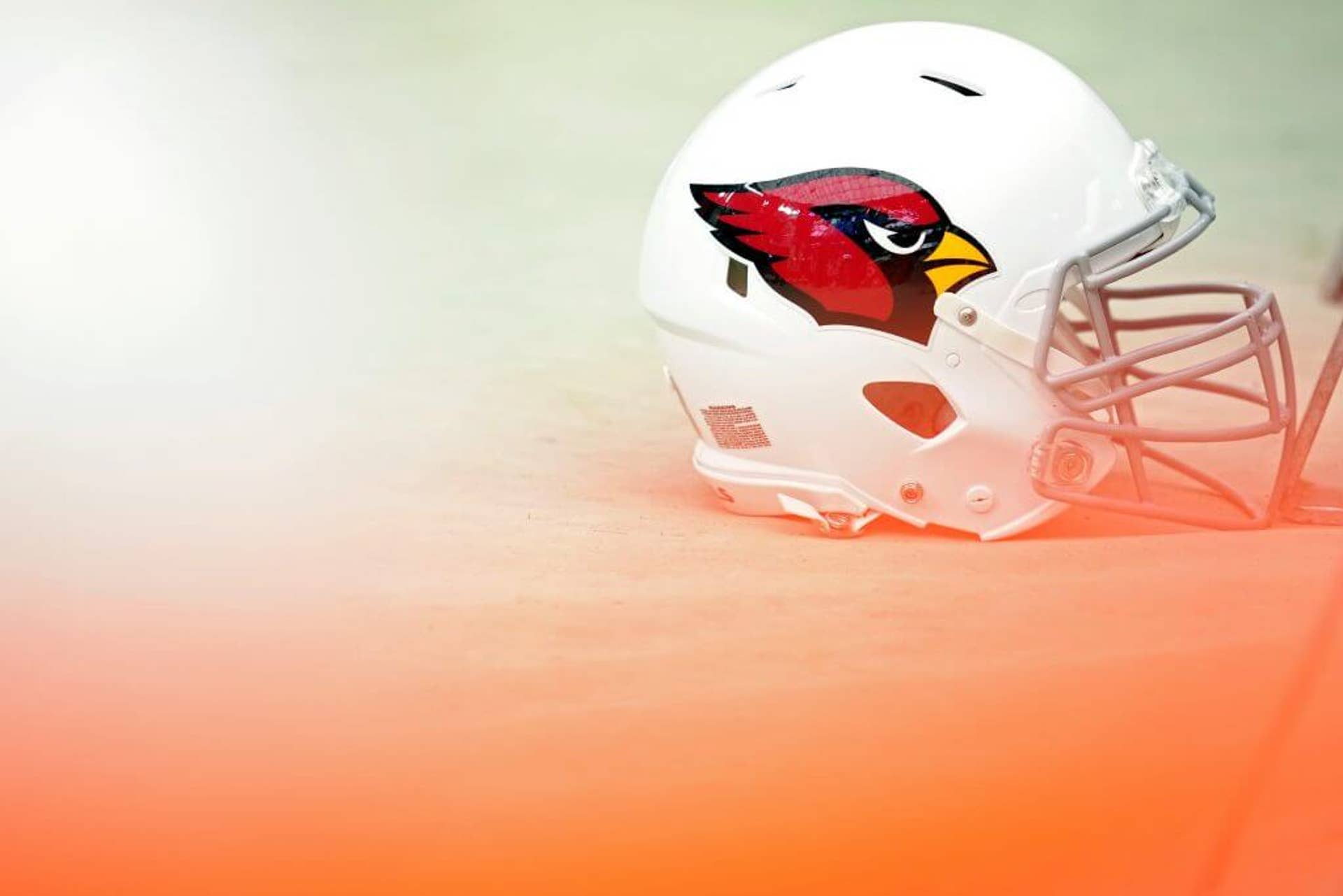 An Arizona Cardinals helmet lies near a football field during a game against the Las Vegas Raiders.