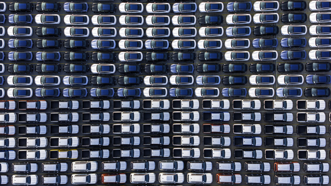 Image of vast rows of vehicles parked for storage.