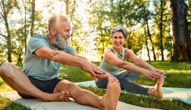 senior man and woman stretch their legs on yoga mats outside