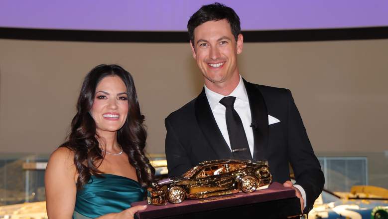 Joey Logano and his wife, Brittney Logano, pose with the Goodyear Gold Car during the 2024 NASCAR Awards celebration in Charlotte.