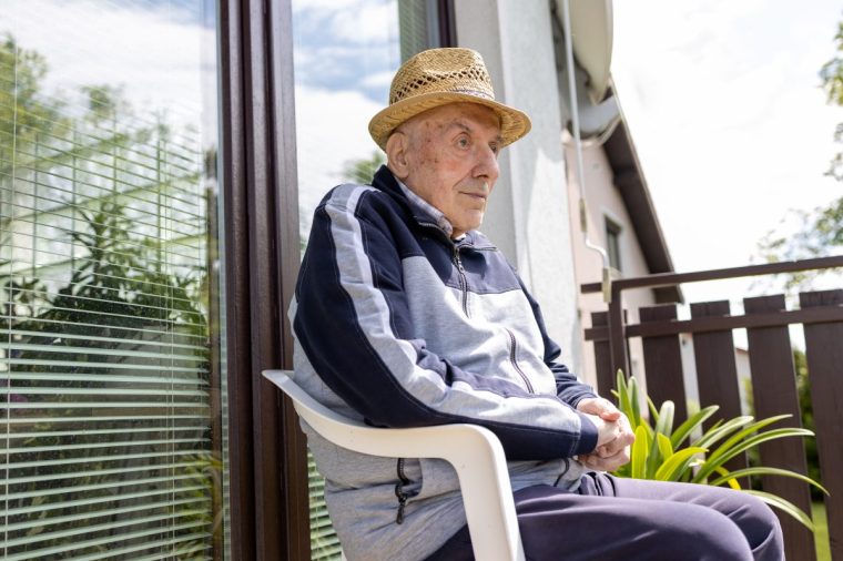 Old man with dementia enjoys sunny weather - stock photo