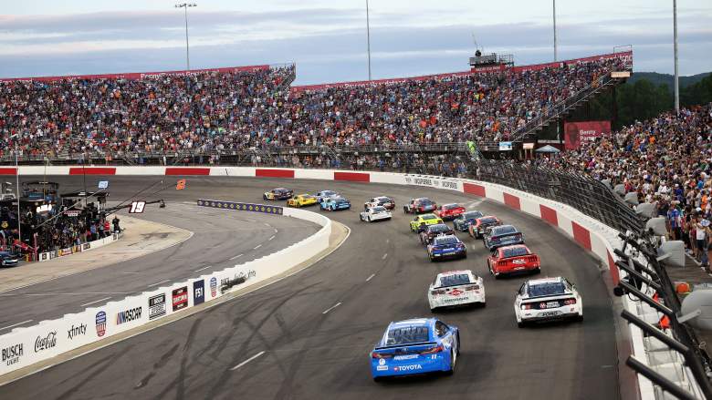 NASCAR Cup Series cars race in front of a packed grandstand during the All-Star Race at North Wilkesboro Speedway.
