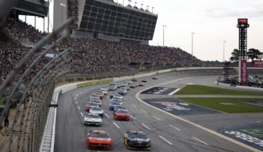 Cars race through Turn 1 during the NASCAR Cup Series Quaker State 400 at EchoPark Speedway.