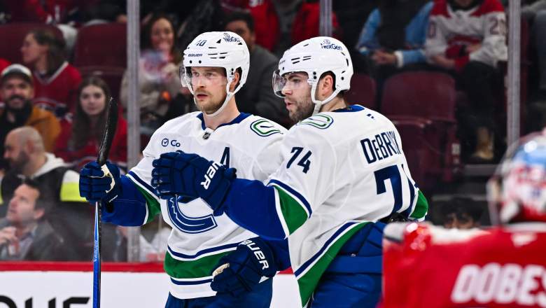 Elias Pettersson #40 of the Vancouver Canucks celebrates his goal with Jake DeBrusk #74 during the first period against the Montréal Canadiens at the Bell Centre on January 12, 2026 in Montreal, Quebec, Canada.