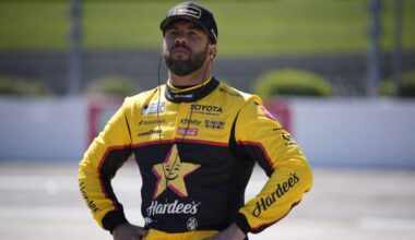 Bubba Wallace stands on pit road at Martinsville Speedway during NASCAR race weekend