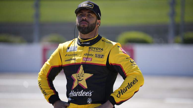 Bubba Wallace stands on pit road at Martinsville Speedway during NASCAR race weekend
