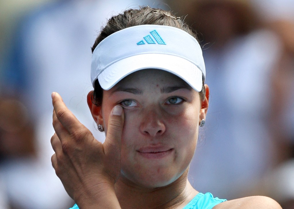 Ana Ivanovic wipes her eyes during a tennis match.