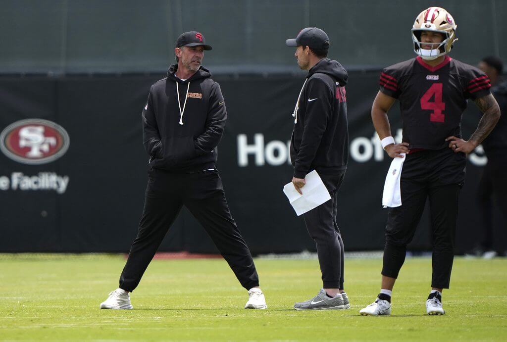 San Francisco 49ers coach Kyle Shanahan talks with offensive coordinator Klay Kubiak during an offseason workout.