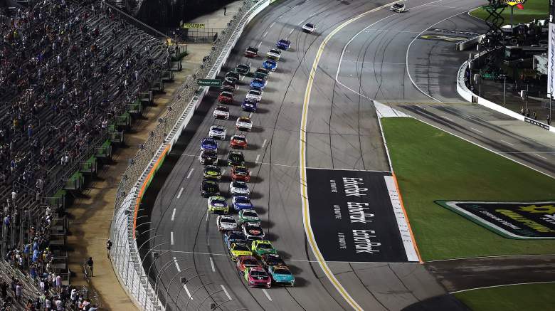 Cars race under the lights during the NASCAR Cup Series Quaker State 400 at EchoPark Speedway.