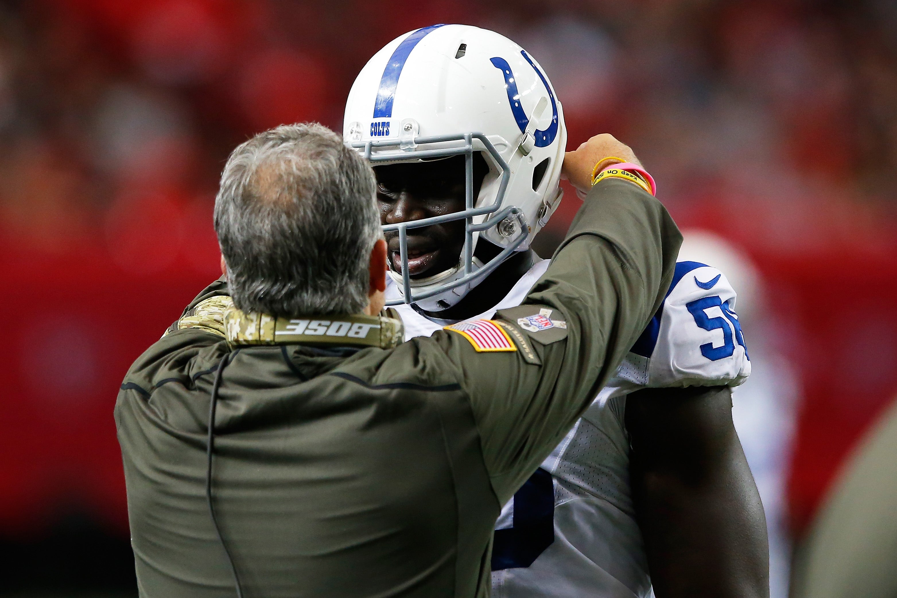 Daniel Adongo #56 of the Indianapolis Colts talks to head coach Chuck Pagano after a penalty during the second half against the Atlanta Falcons at the Georgia Dome on November 22, 2015 in Atlanta, Georgia