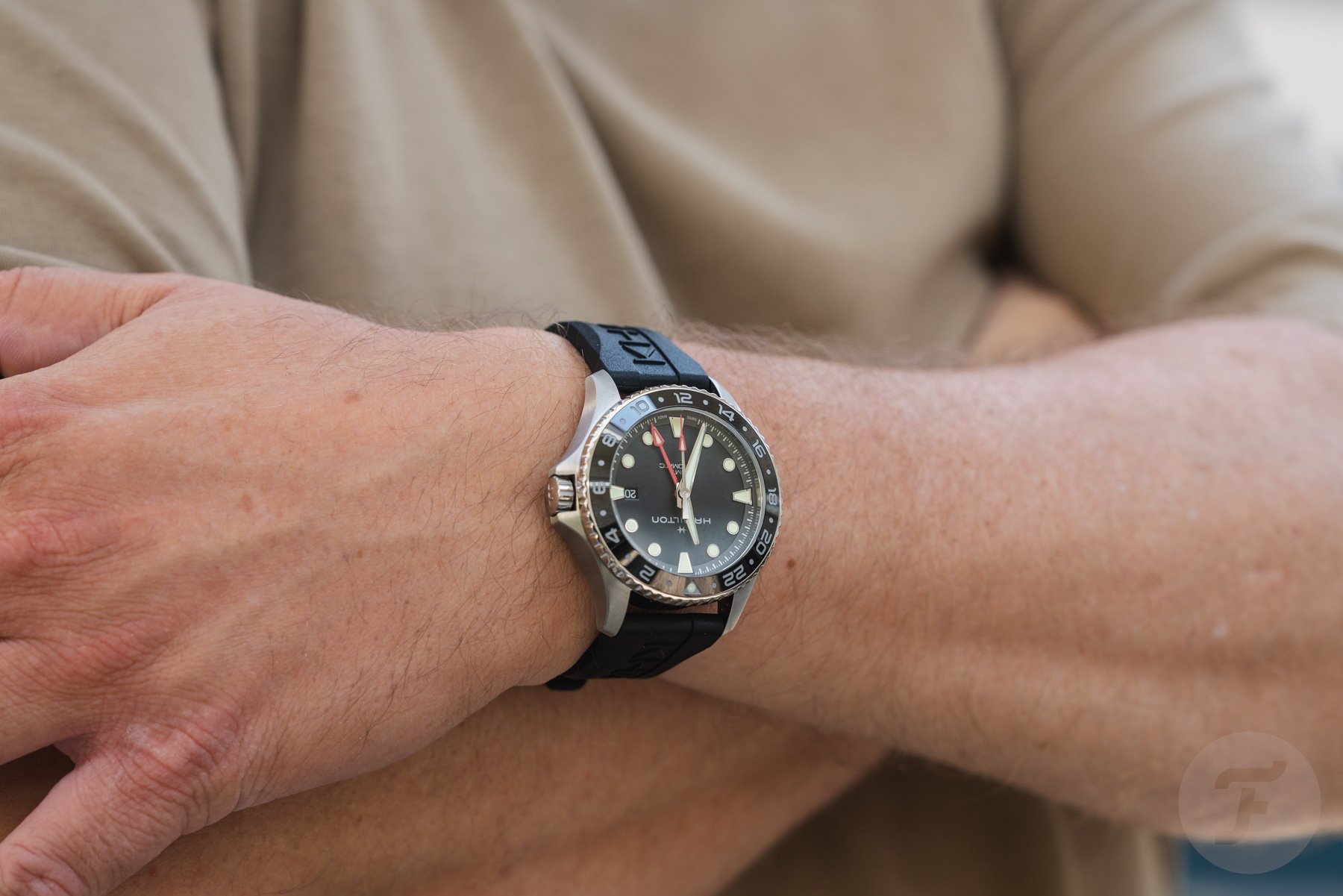 Hamilton Khaki Navy Scuba Auto GMT on wrist, arms crossed