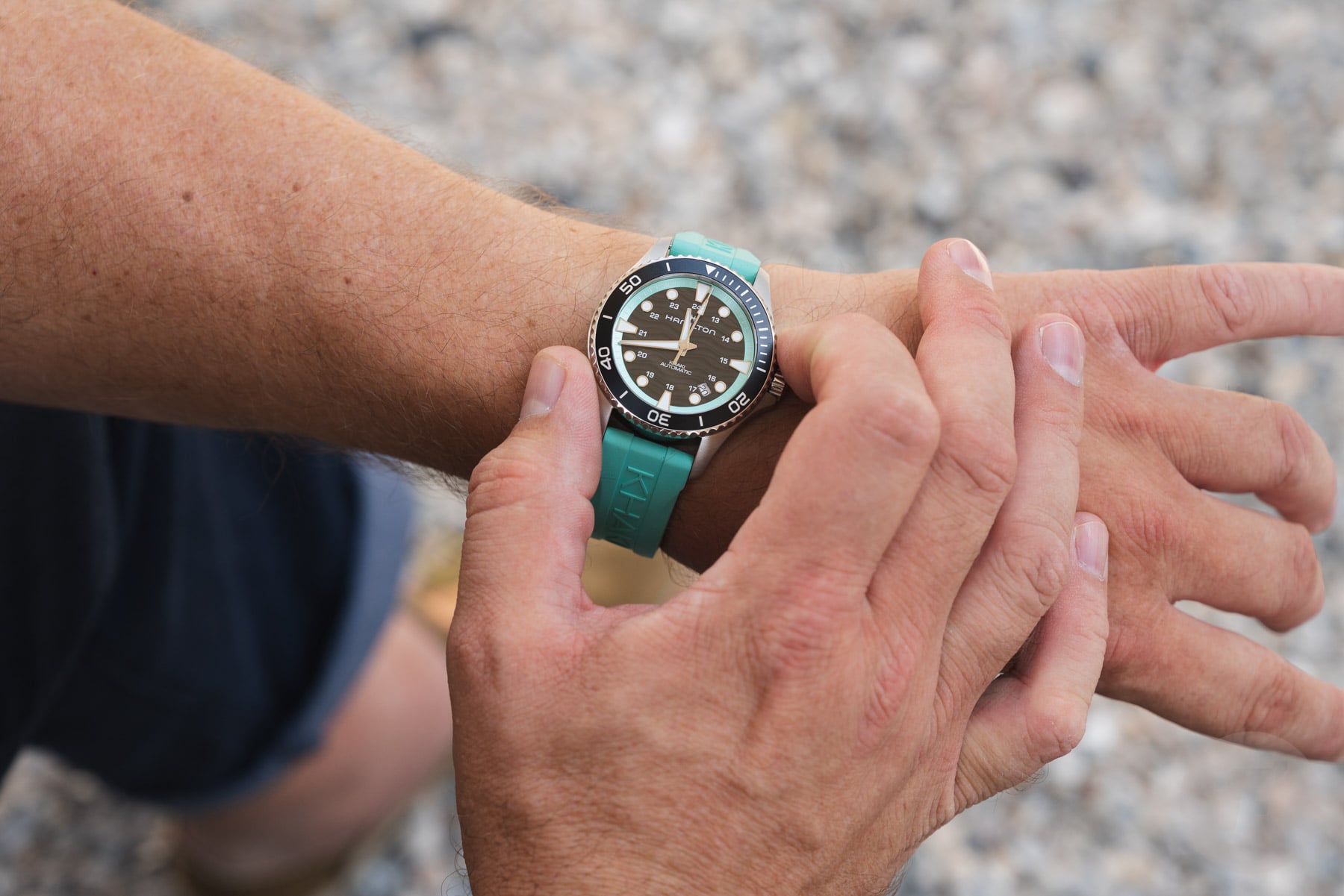 Hamilton Khaki Navy Scuba Auto on wrist, fingers on bezel