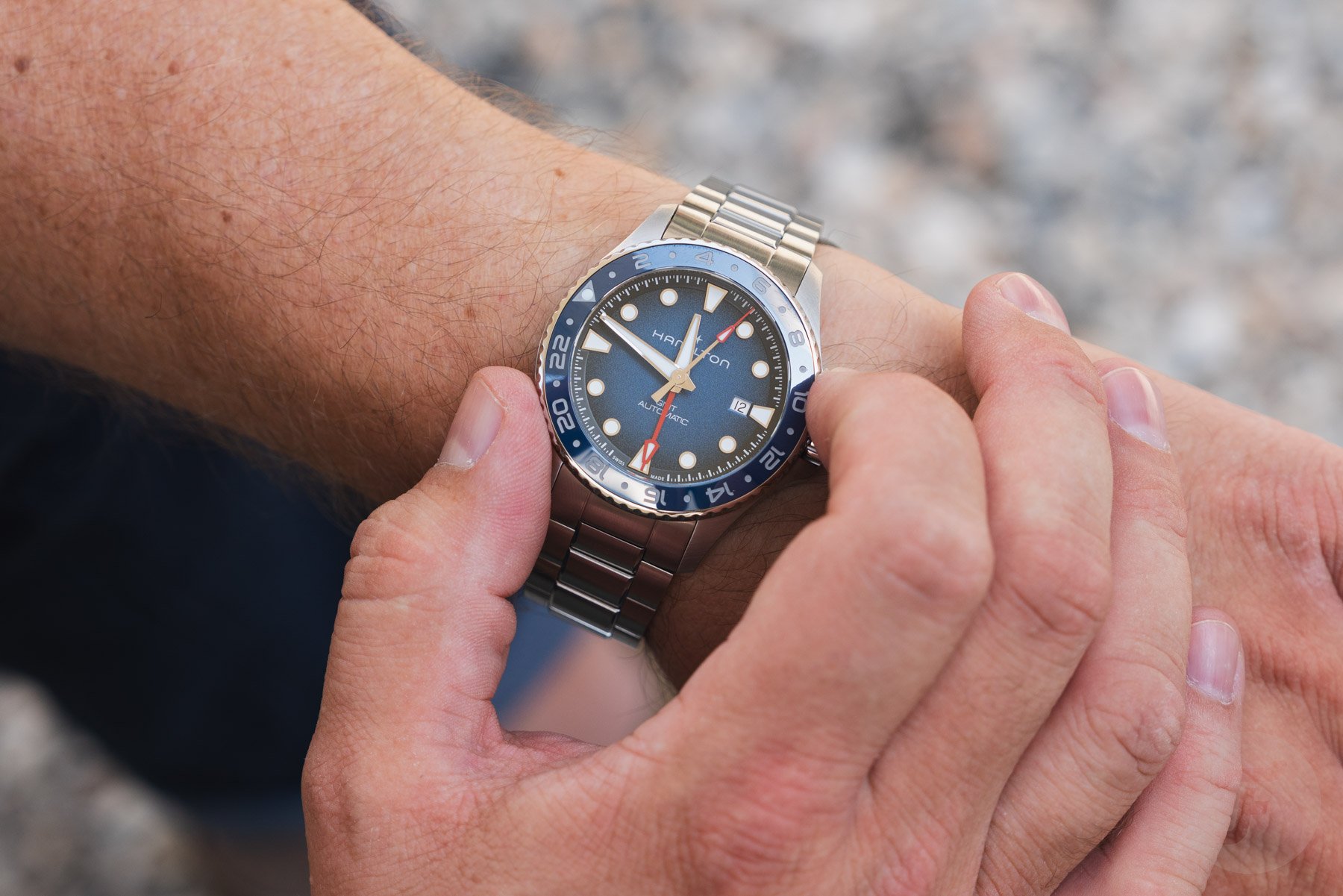 Hamilton Khaki Navy Scuba Auto GMT on wrist, fingers on bezel
