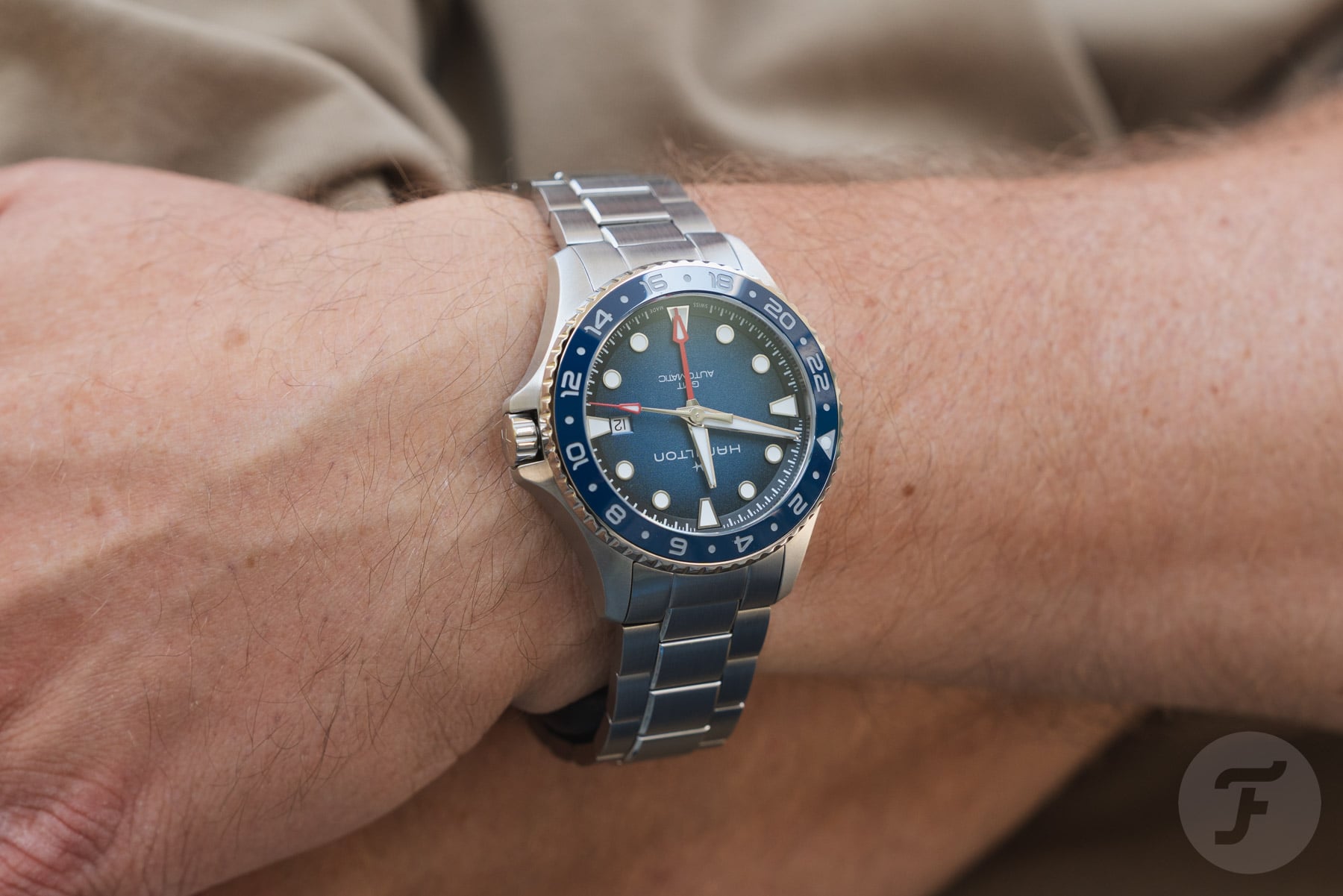 Hamilton Khaki Navy Scuba Auto GMT on wrist, arms crossed