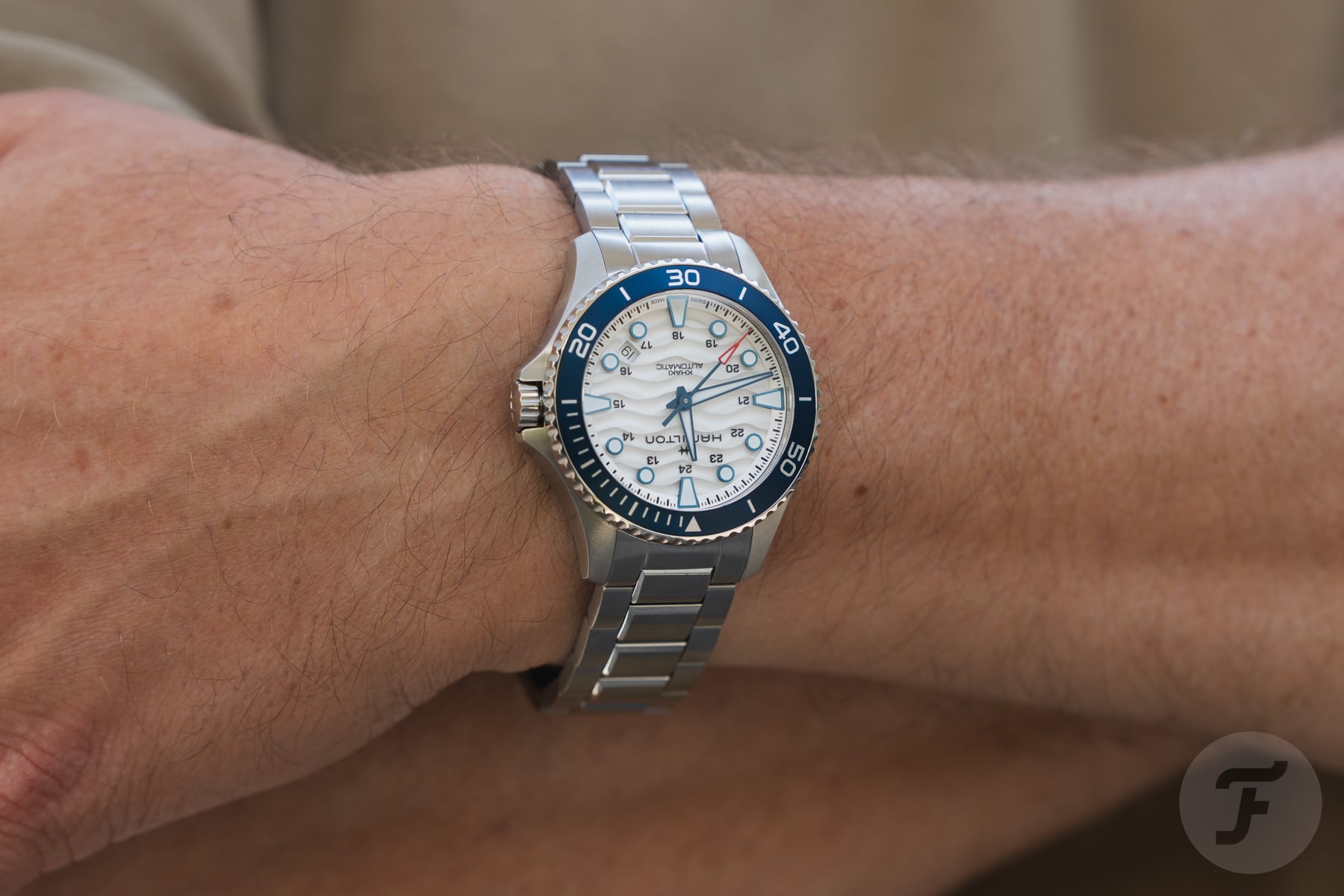 Hamilton Khaki Navy Scuba Auto on wrist, arms crossed