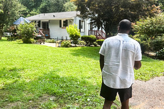 Daronte Jones looks at the house he moved to with his mother in middle school.