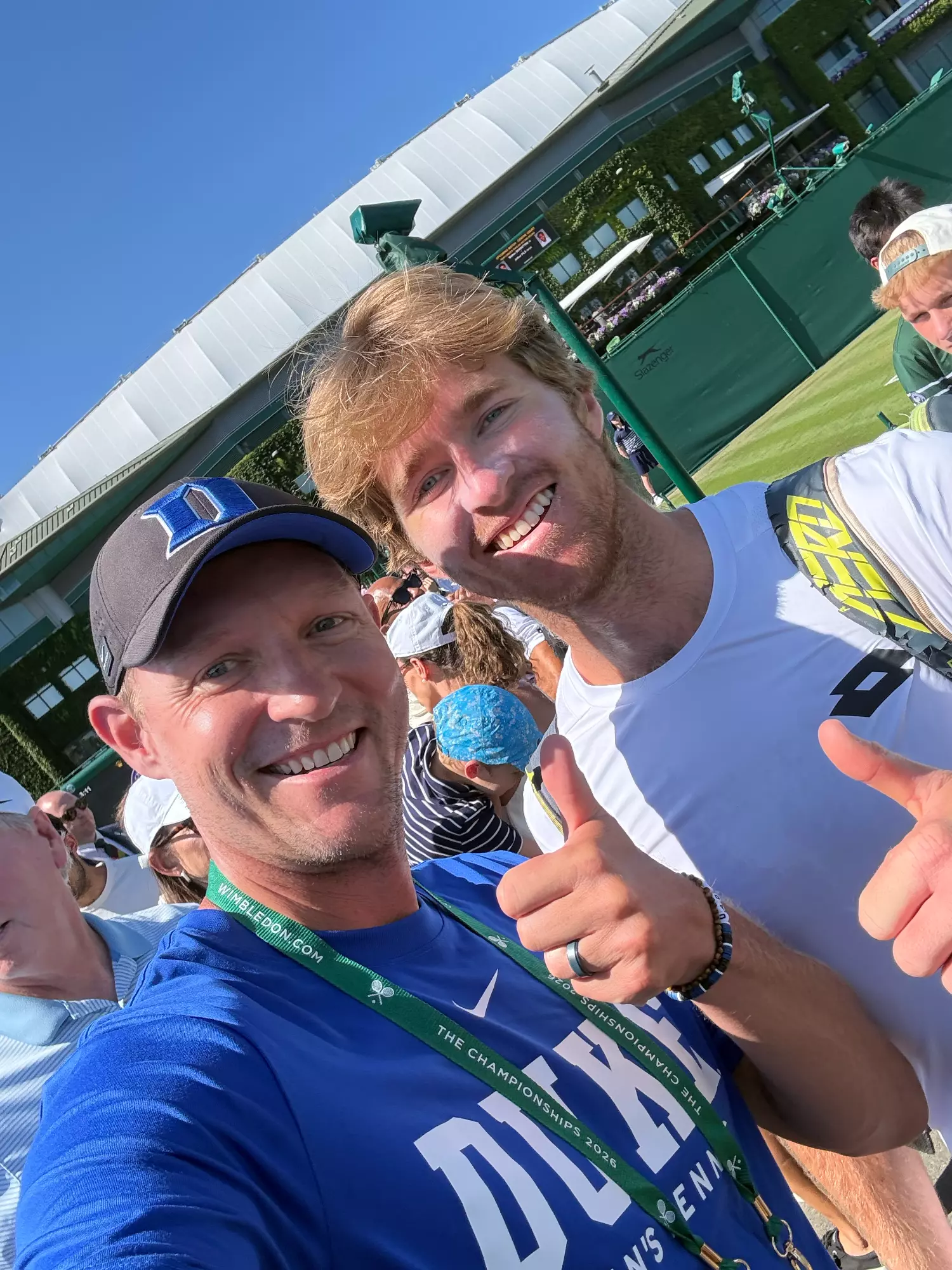 Former Duke men's tennis players Theo Winegar and Ramsey Smith pose for a photo at Wimbledon after Winegar's first round doubles victory in 2026.